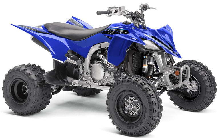Yamaha YFZ450R ATV showing rugged tires, sporty body design, and handlebar controls on a dirt trail.