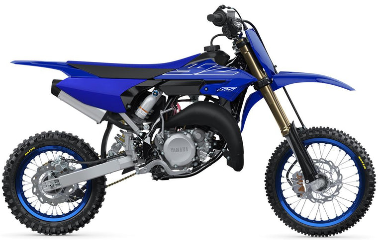 Yamaha YZ65 motocross motorcycle in blue with knobby tires and suspension, ready for off-road riding.