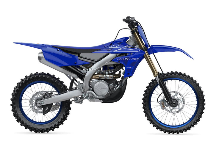 Yamaha YZ450FX off-road motorcycle with knobby tires and racing graphics, ready for dirt trail riding.