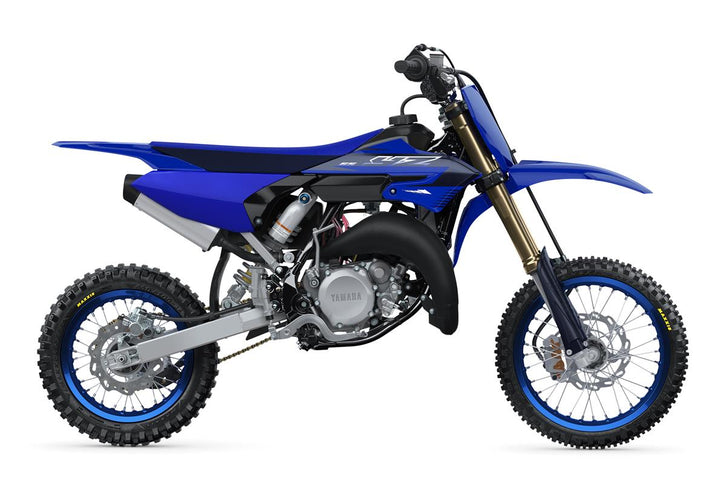 Blue Yamaha YZ65 2023 dirt bike with knobby tires, front suspension, and a compact frame, viewed from the side.